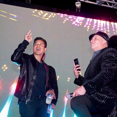 Mario Lopez points to the sky on stage at Pied Piper's New Year's Eve at WTR at The Godfrey, Tampa